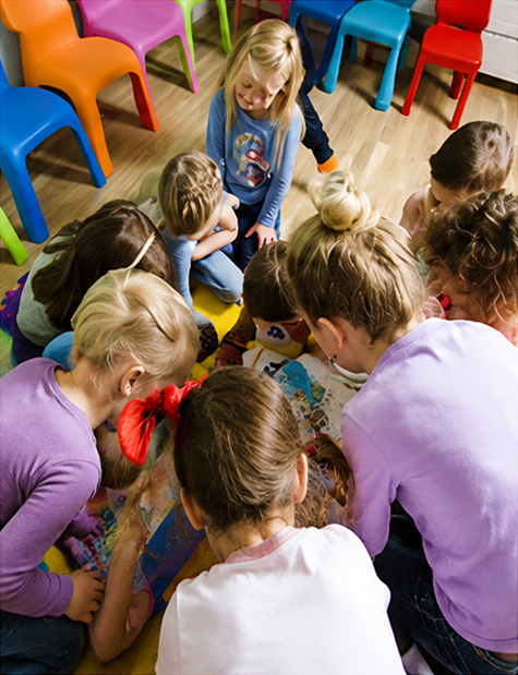 Children reading together in a circle